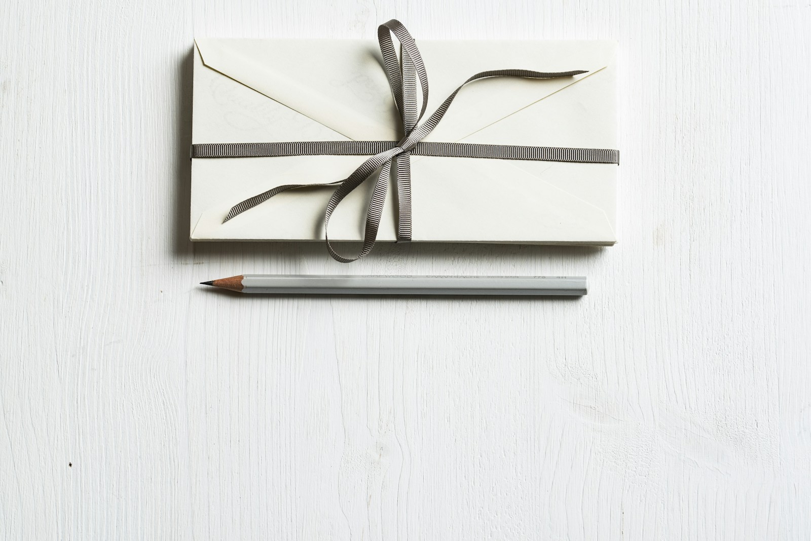 Envelope and pencil on a clean desk
